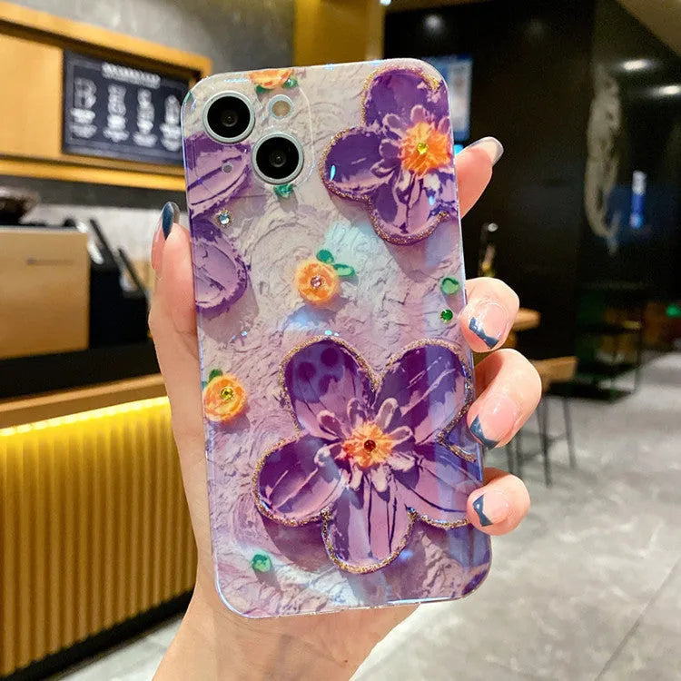 Purple soft rubber phone case with oil painting flower design and inlaid diamond detailing.