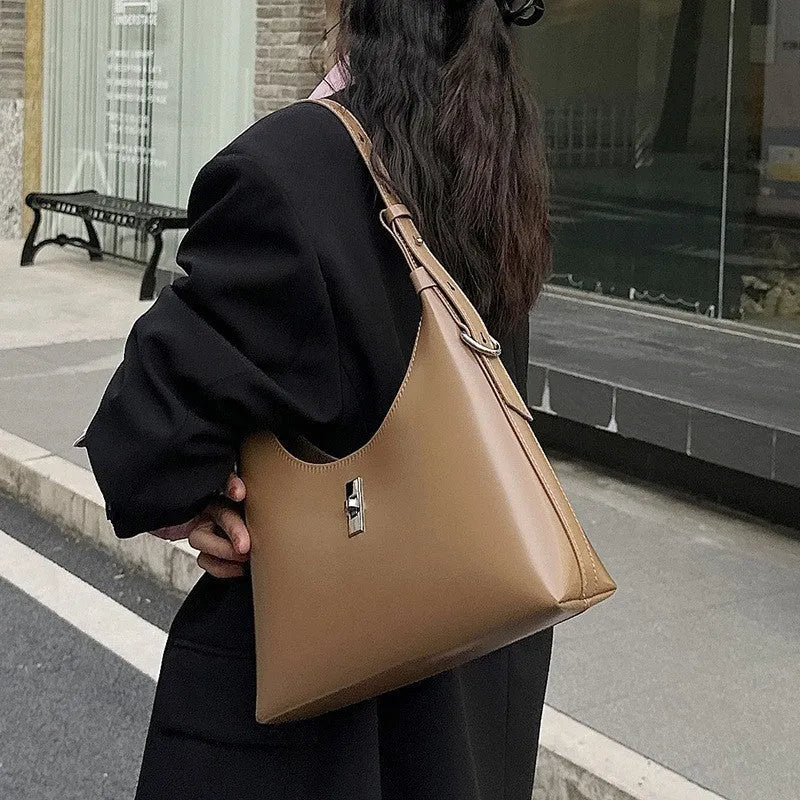 Genuine leather dumpling-shaped crossbody bag in apricot colour with an outer sandwich pocket