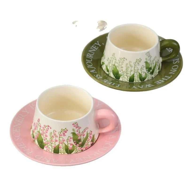 Ceramic coffee cup and saucer set for couples with stirring spoons in two design options.
