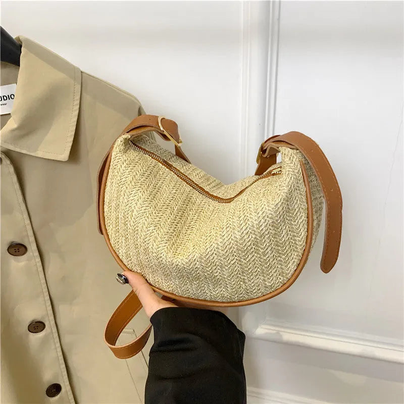 Straw woven crossbody bag showing woven texture and interior phone compartment
