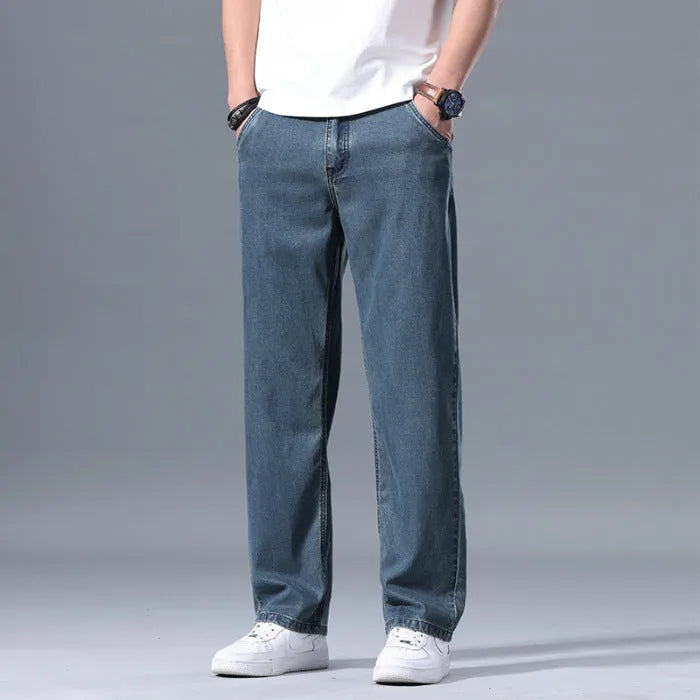 Men's loose straight-leg jeans in a lyocell-blend denim, shown in light blue colour with a zipper fly.