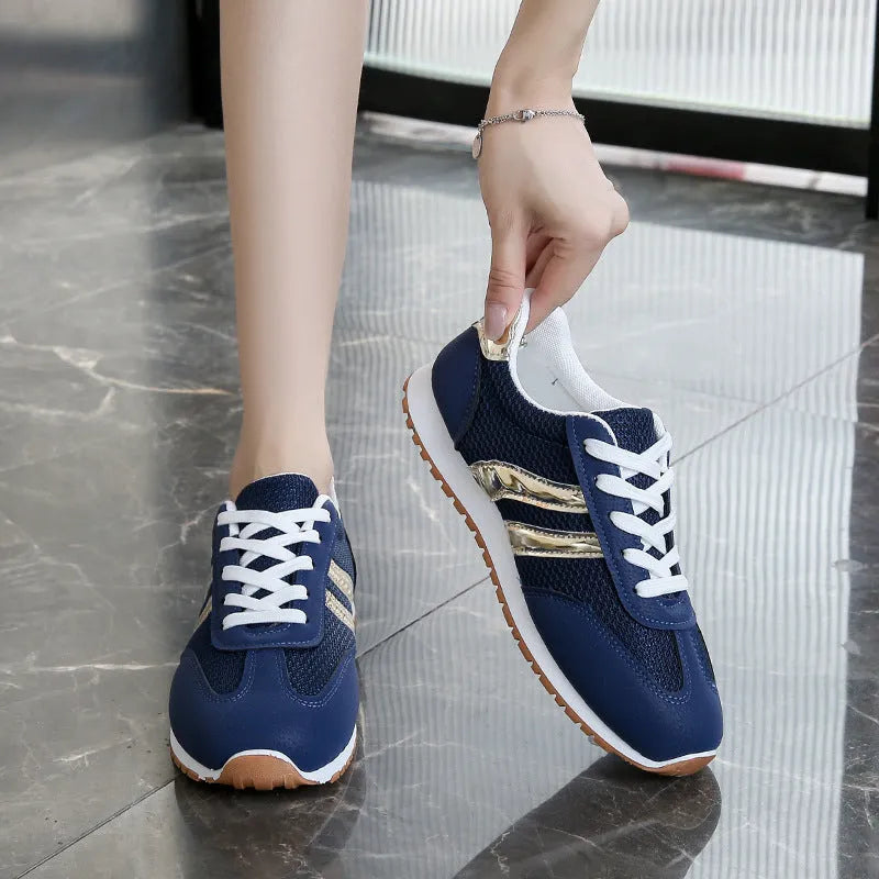 Blue women's casual sports shoes with cross shoulder straps and white rubber sole, shown on a size label.