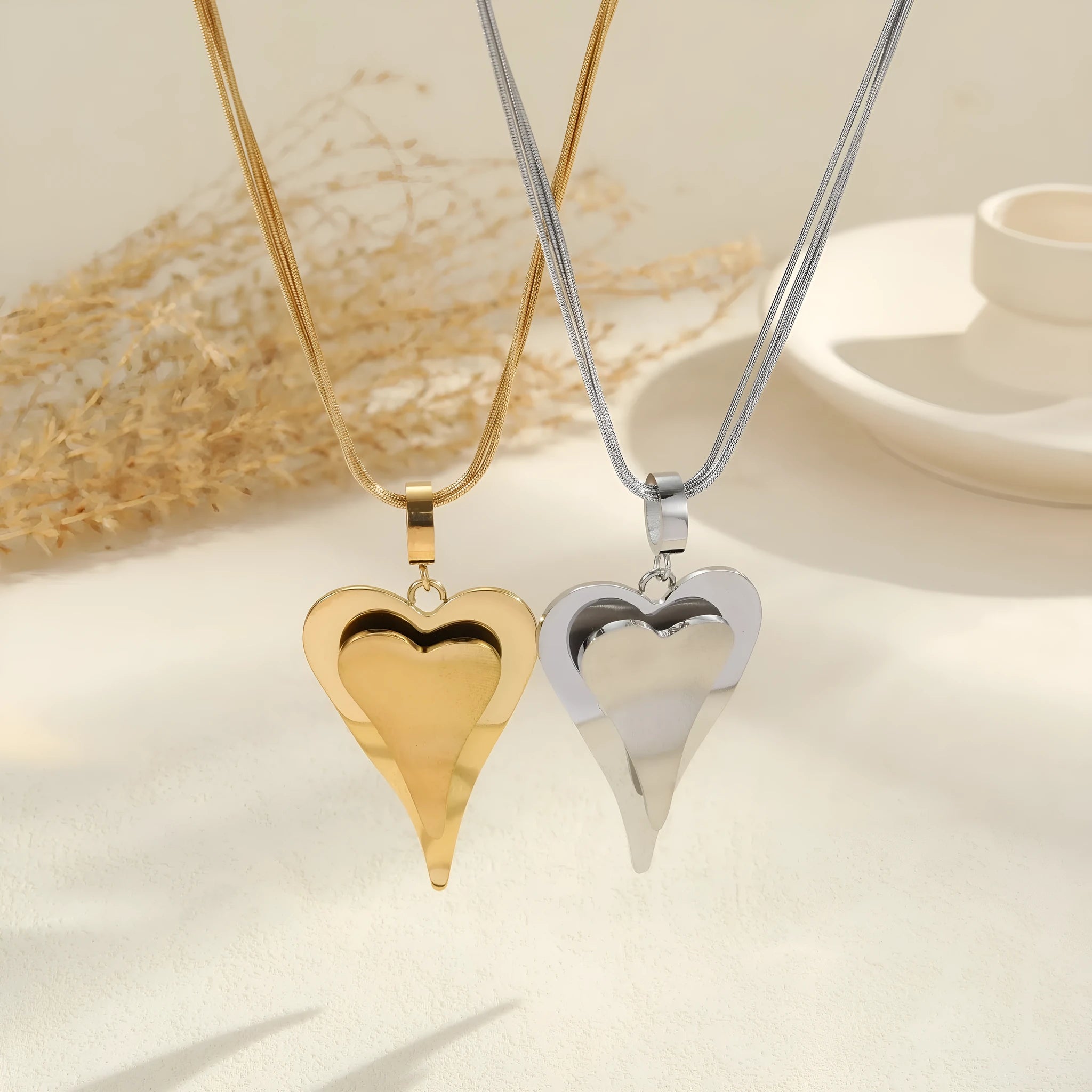 Stainless steel double heart snake bones chain necklace with geometric pendant in gold or steel electroplated finish