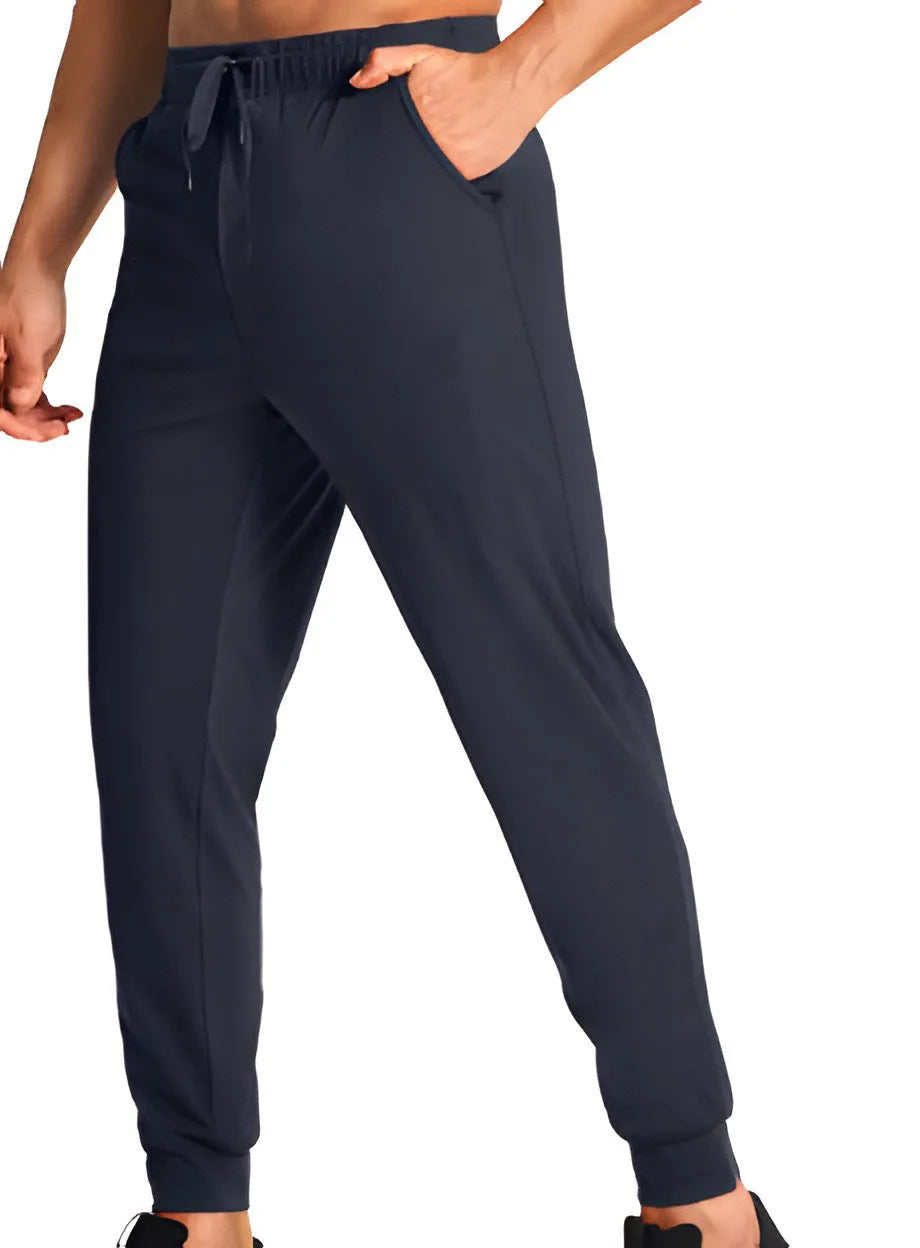 Men's loose-fit solid colour casual trousers made from polyester fabric on a hanger.