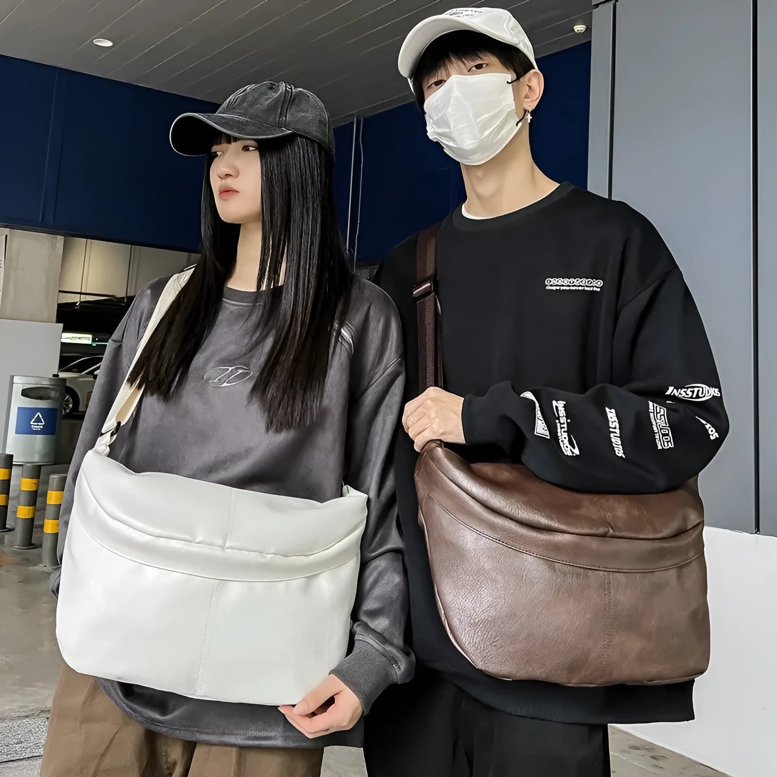 Retro large capacity men's crossbody bag in brown PU leather with zipper closure on white background.