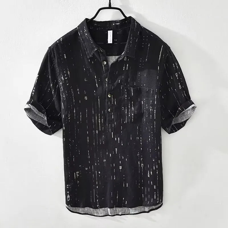 A man's loose-fit short-sleeved polo shirt in black, showing the lapel collar and casual cardigan style.
