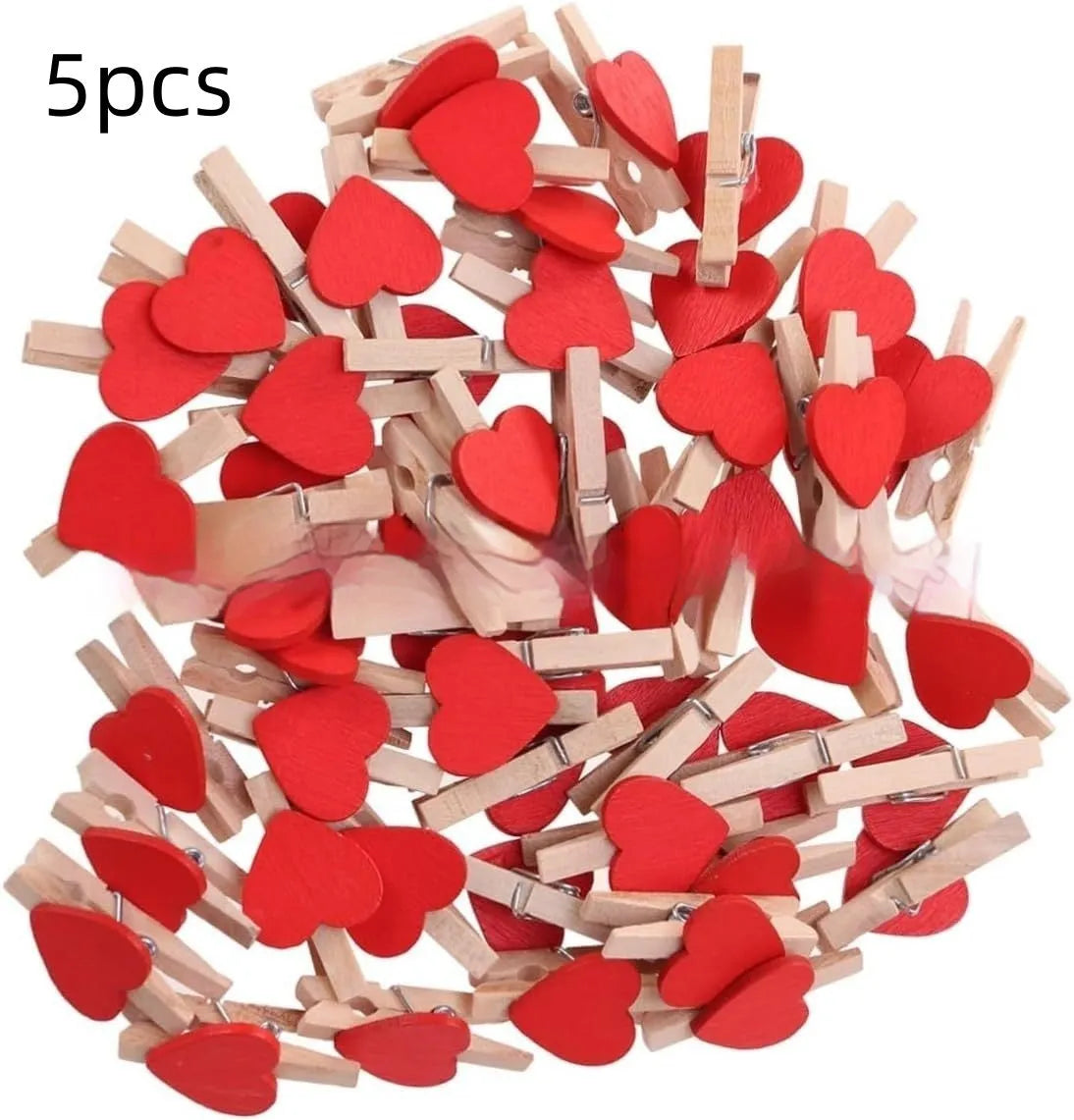 Set of five solid wood heart-shaped clips in different colours on wooden surface