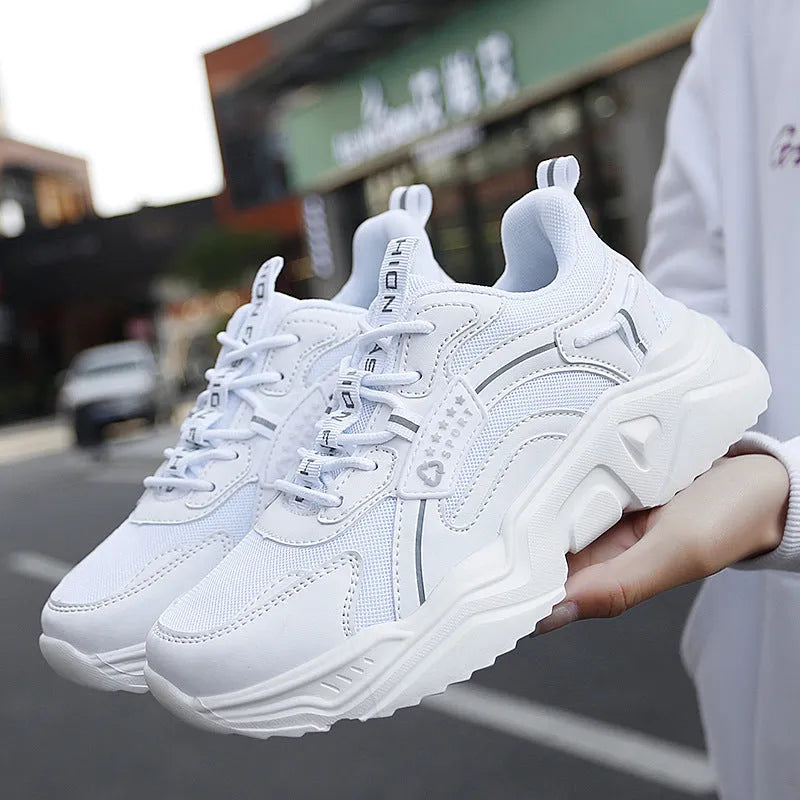 Women's white thick-soled casual sports shoes with mesh upper, round toe, and buckle closure.