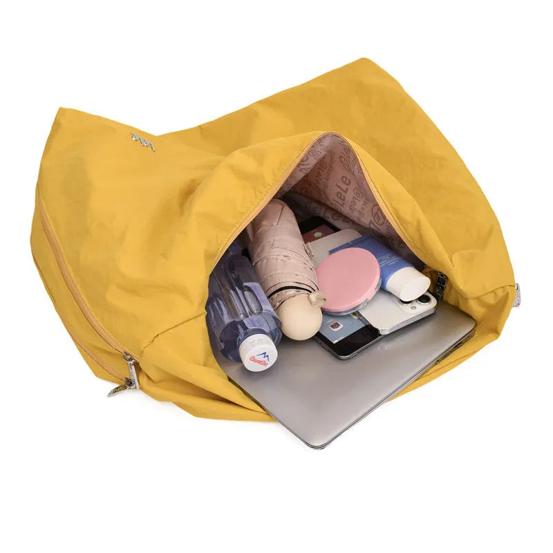 Women's soft nylon underarm bag in a heart shape, shown in black, blue, khaki, and yellow colour options.