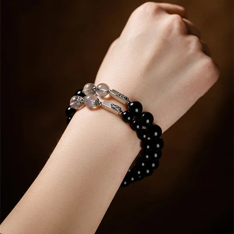Obsidian couple bracelet DIY set with 8mm and 10mm Buddha beads on adjustable string.