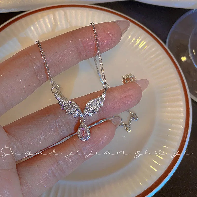 Women's sterling silver necklace with a choice of fishtail or angel wing pendant on an O-ring chain.