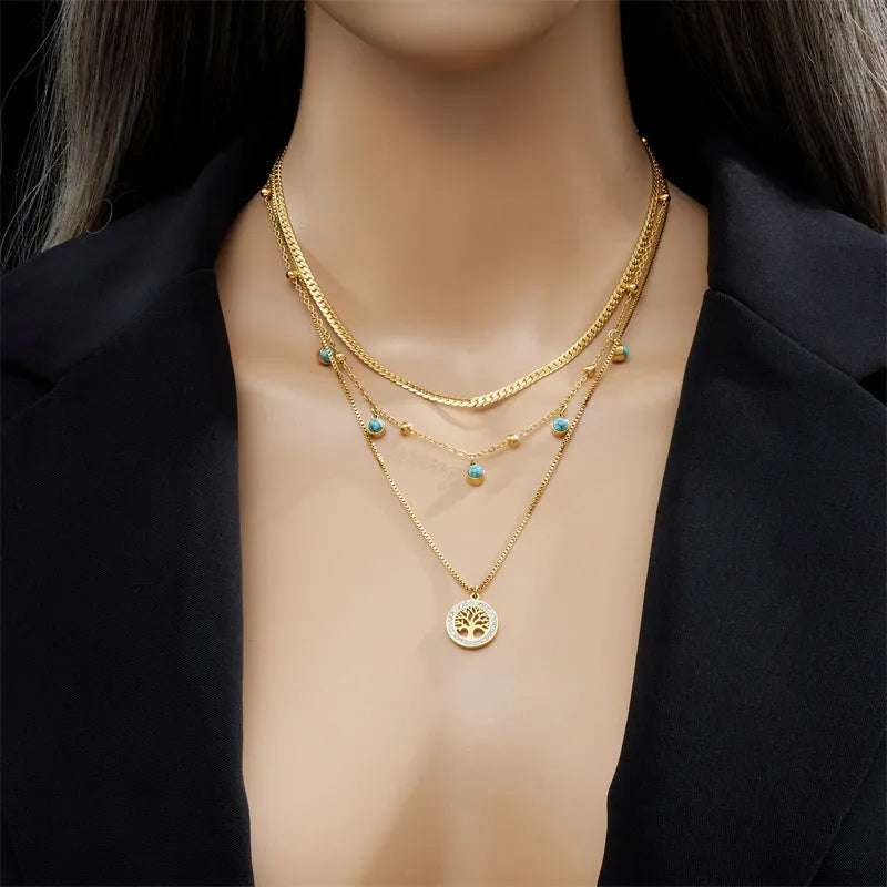 Gold-plated multi-layer stainless steel necklace with geometric tree pendant on woman