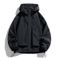 Man wearing a black hooded windproof waterproof jacket with long sleeves.