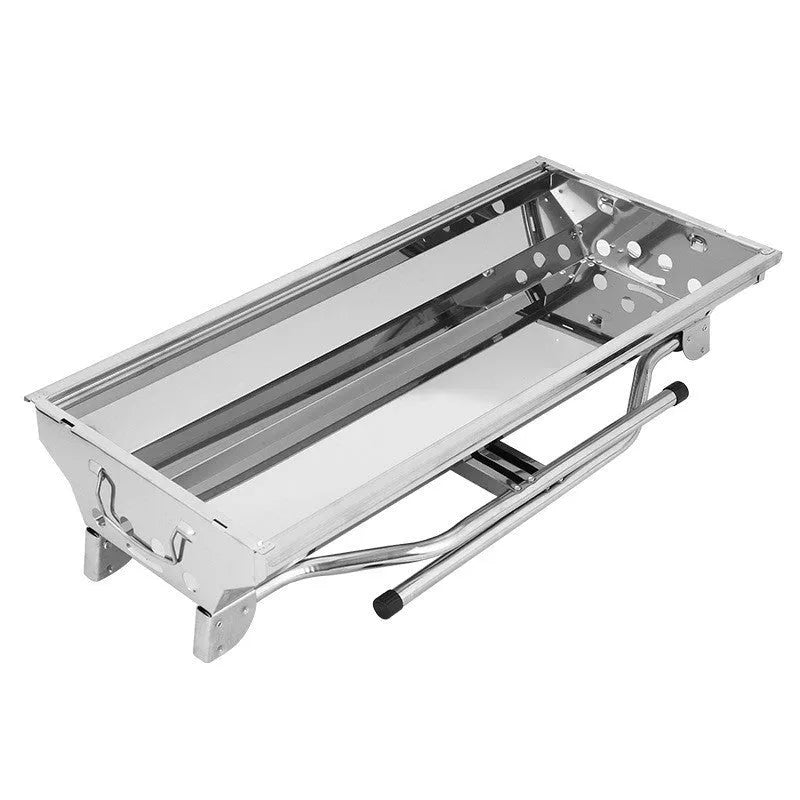 Stainless steel portable folding barbecue oven with grills, shown outdoors.