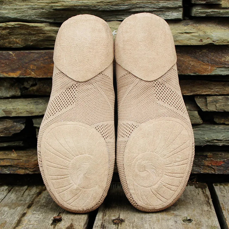 Camel coloured Latin dance shoes with cotton mesh upper and leather sole on a plain background.