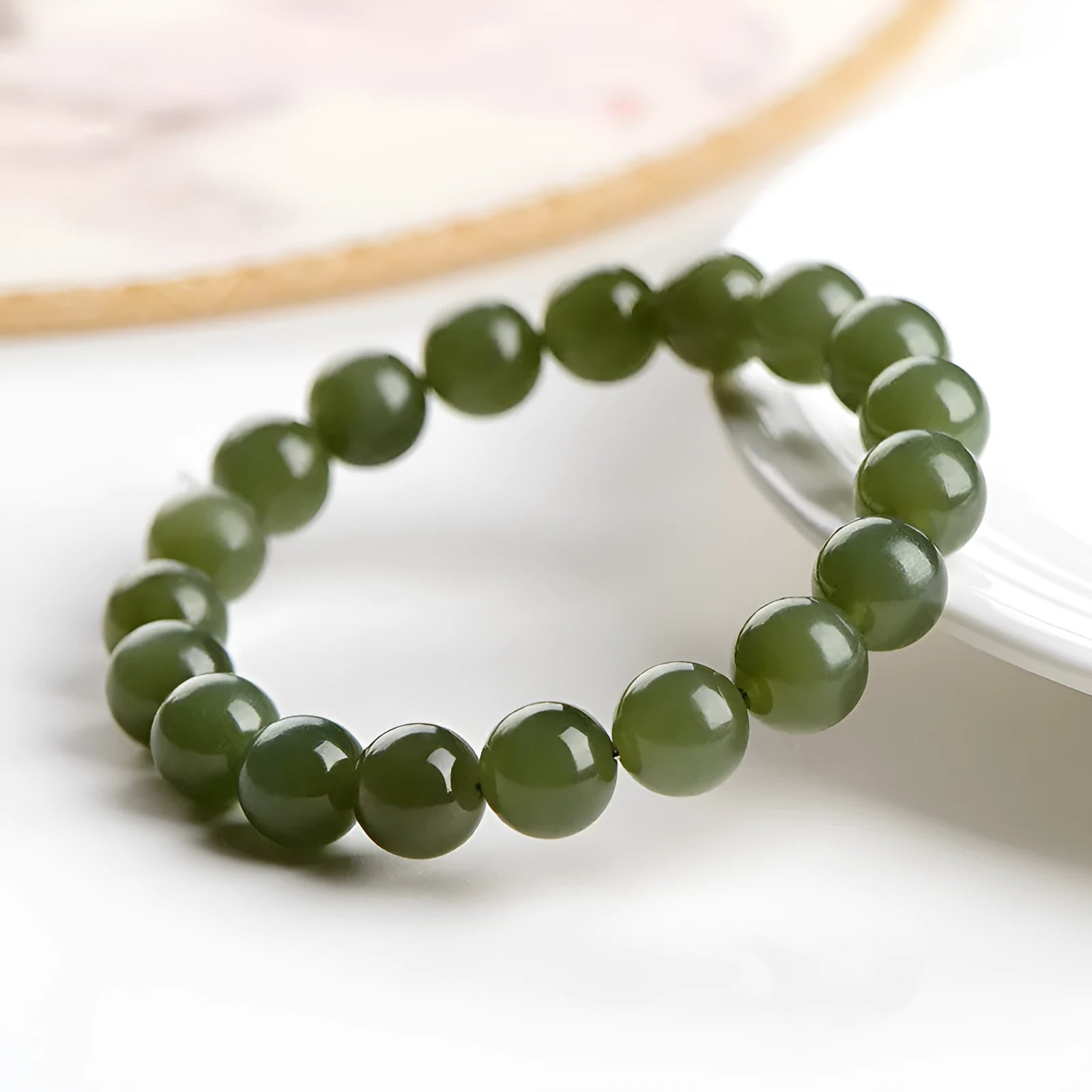Polished Hetian jade bead bracelet in ice-like clear water colour on a wrist.