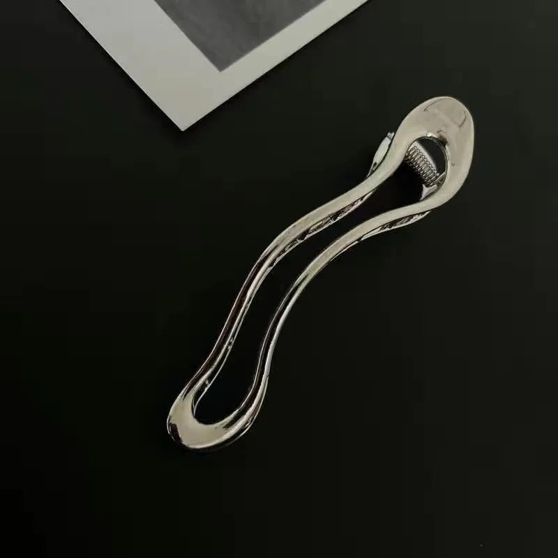 Gold and silver zinc alloy hair clips in arc, square, and triangle geometric shapes