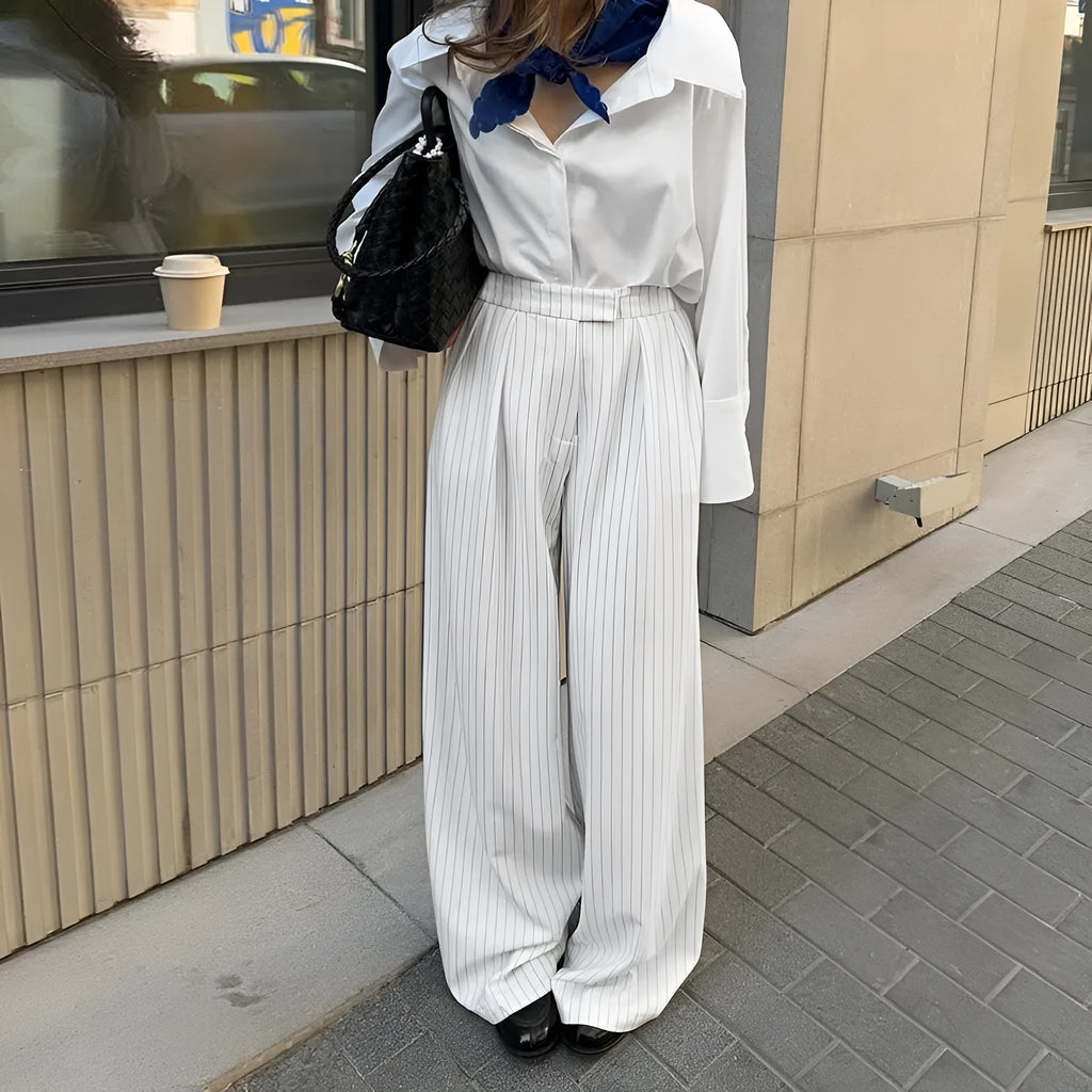 White striped wide-leg casual trousers with a zip closure on a hanger.