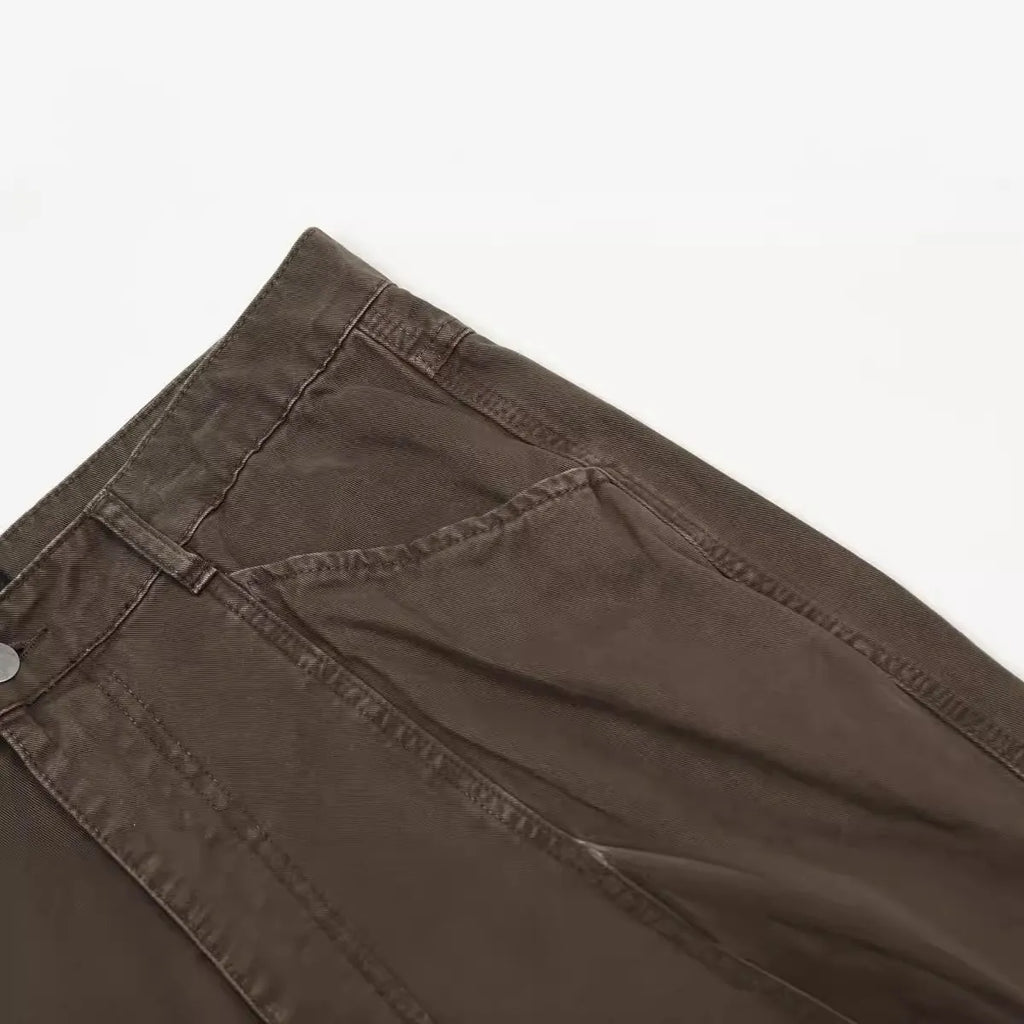Man wearing brown loose fit high-waist straight leg cotton jeans trousers