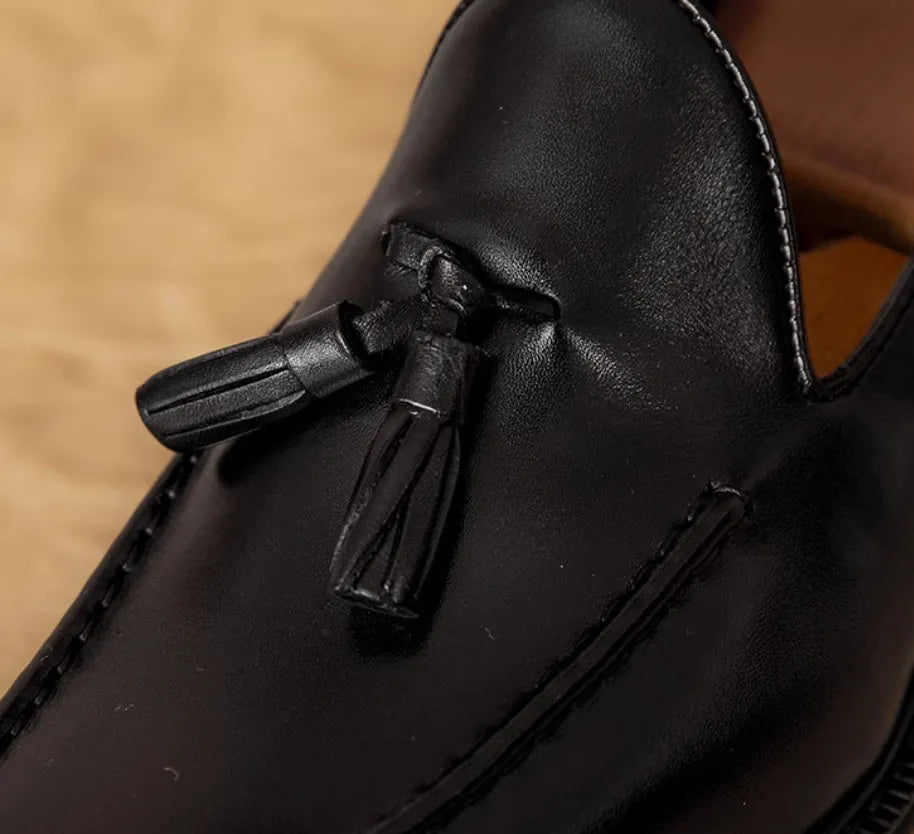 Men's black and brown genuine leather slip-on loafers with a polished finish and rubber sole.