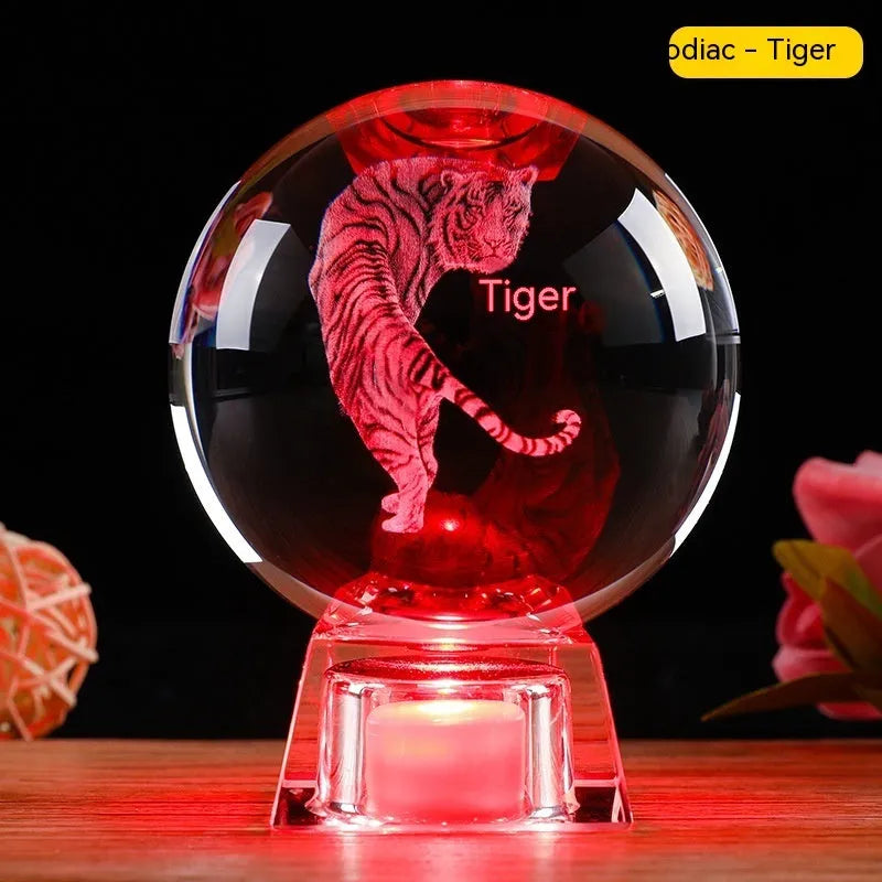 White crystal zodiac decorative ball with electronic base lighting showing Chinese-style animal design