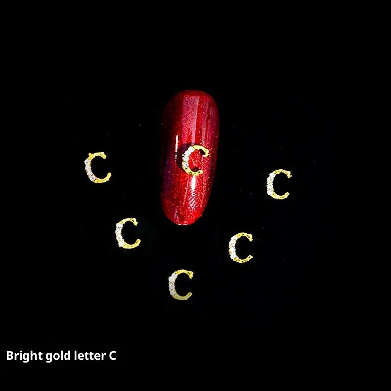 Gold alloy letter A nail ornament charm with crystal detail on a square chain base