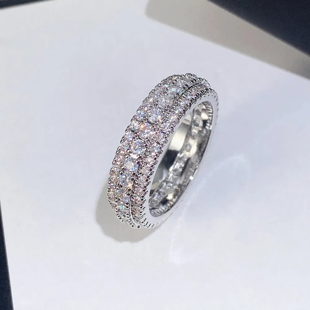 Geometric triangle engagement ring with zircon stone in yellow gold finish on a copper band.