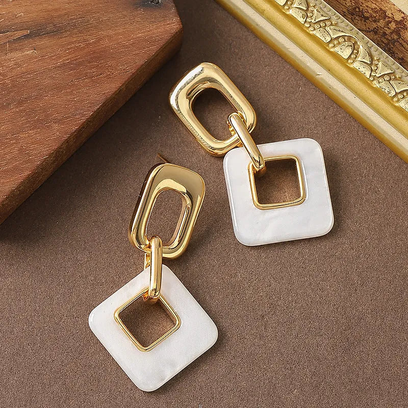 Hollow geometric square earrings with chamfered corners in silver or black