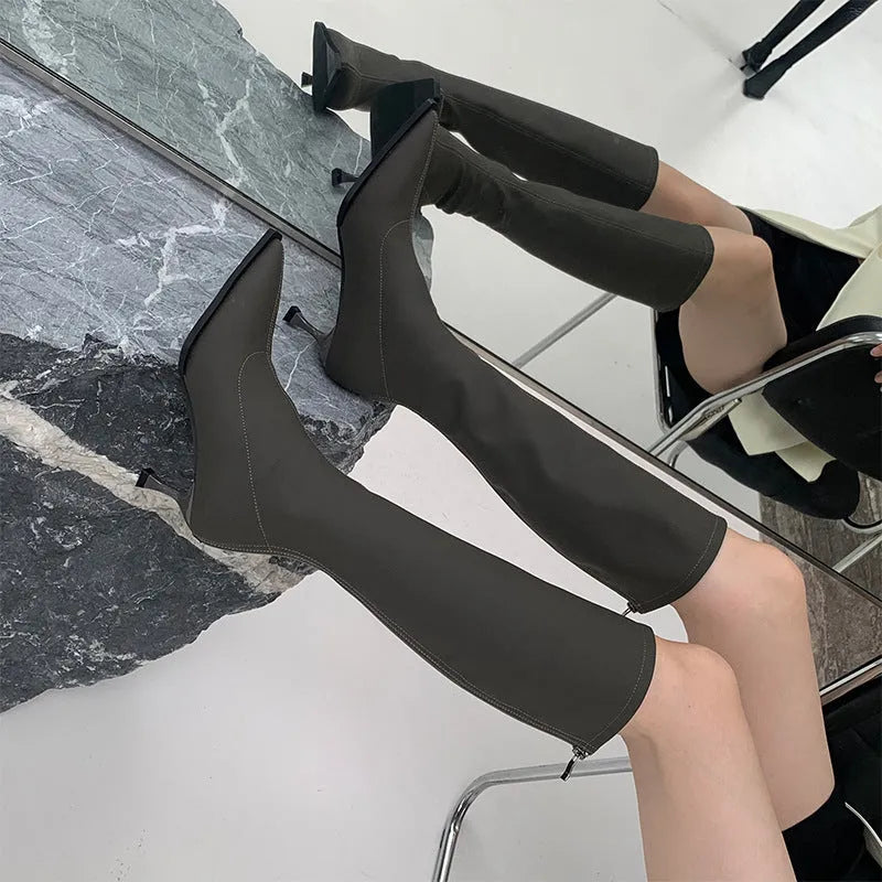 Women's black pointed toe stiletto heel boots with a back zip closure