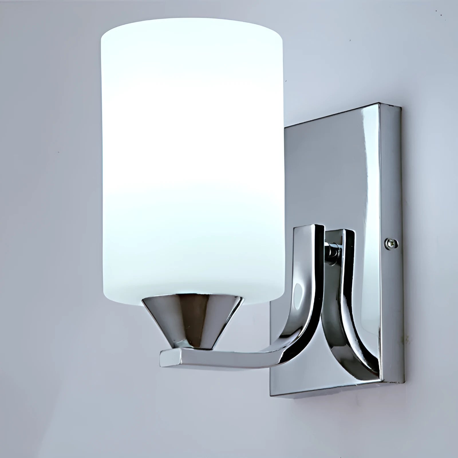 Minimalist chrome-finished glass wall lamp with single head configuration on white wall