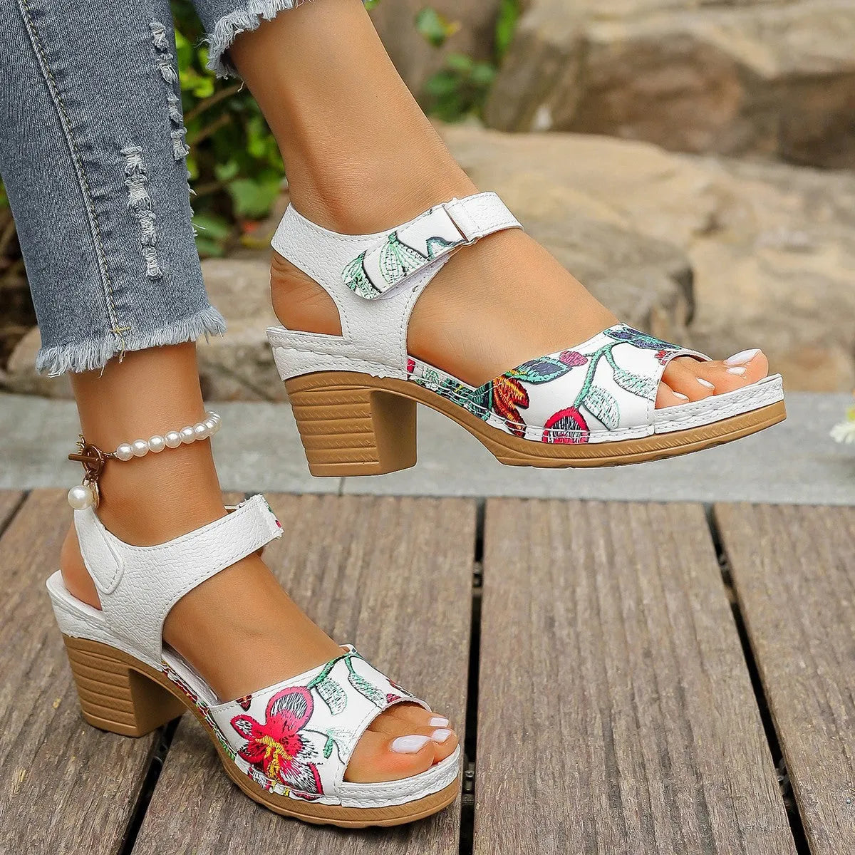 White women's high heel sandals with a visible Velcro strap buckle on a rubber sole.