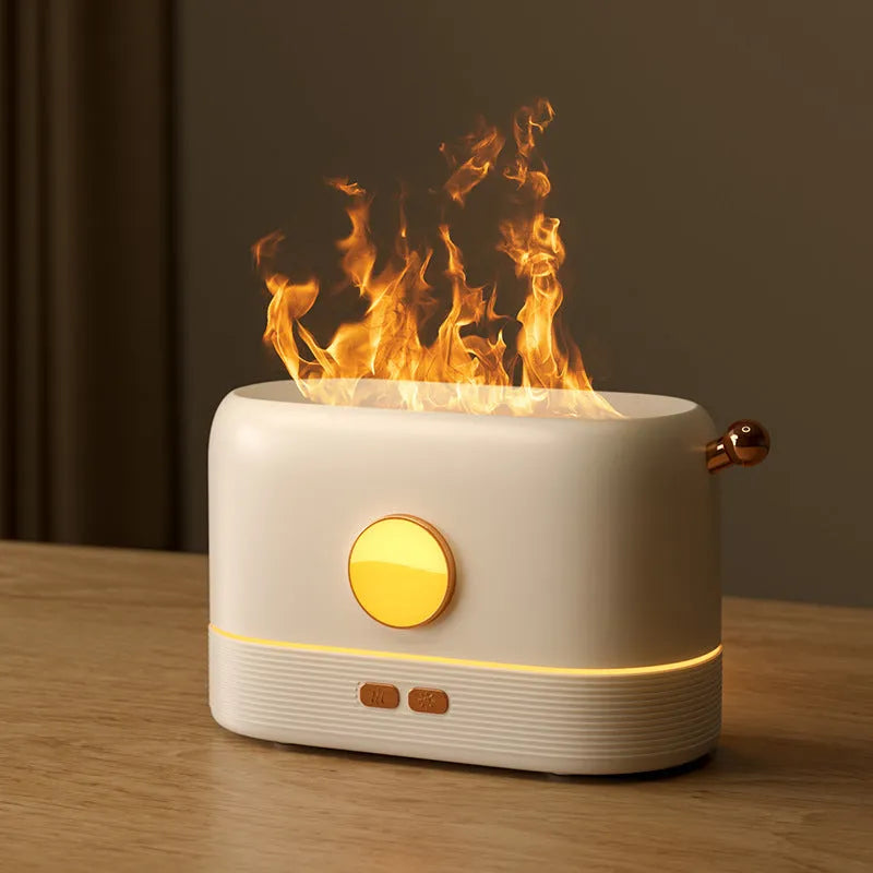 Black USB desktop humidifier with decorative orange flame effect and water tank on a wooden desk.