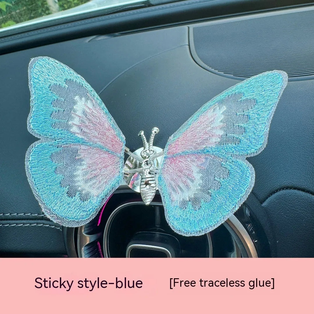 Moving embroidery butterfly decoration on car centre console air vent in pink fabric