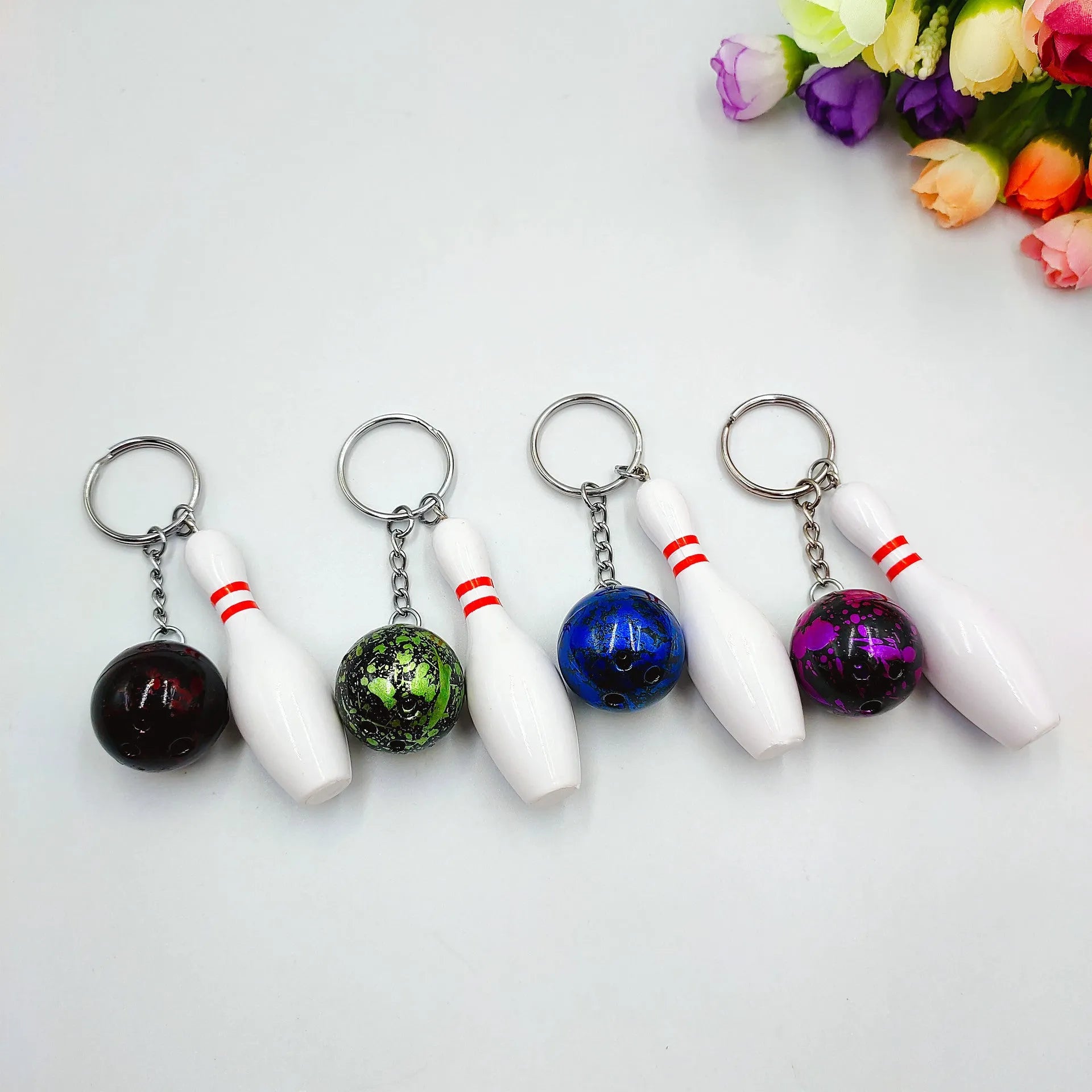 Mini bowling pin keychain pendant in four colour options with key ring attachment