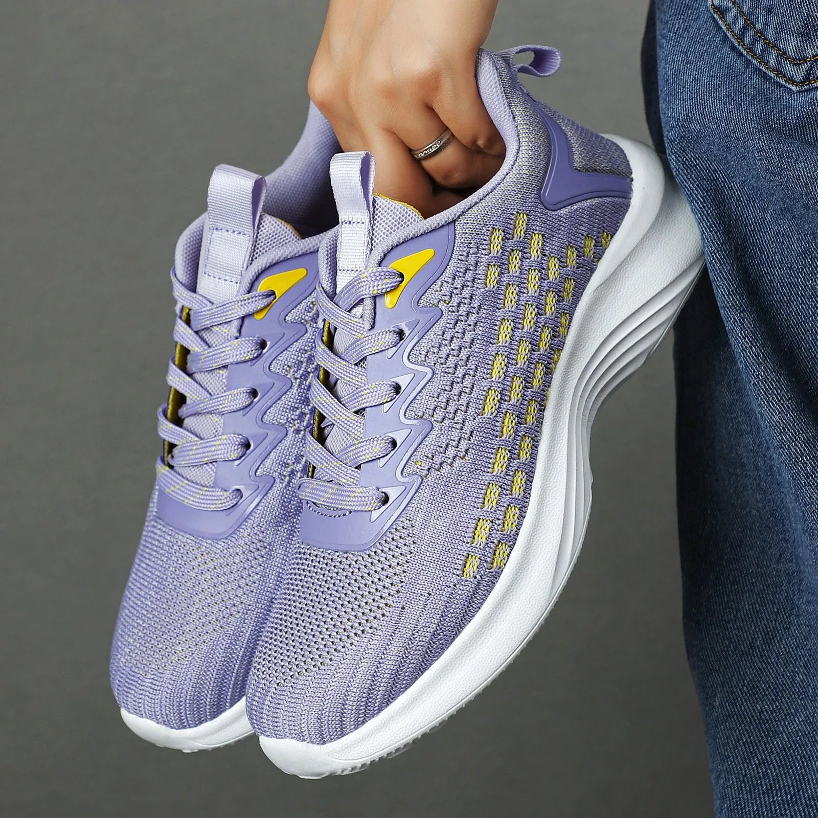 Lavender purple women's Flyknit running shoes with striped pattern, mesh lining, and a flat EVA wedge sole.