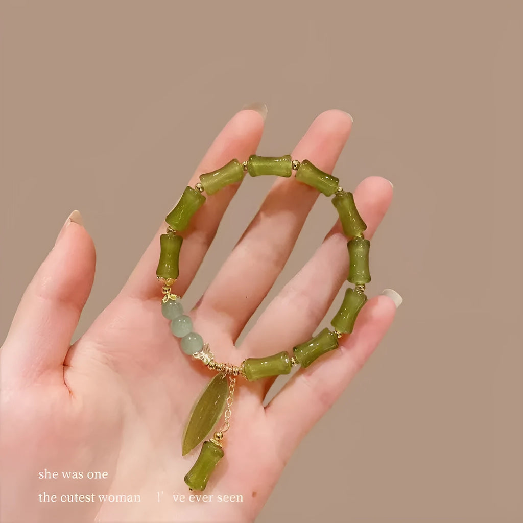 Chinese style glass bracelet with bamboo joint details in a red Lvzhu Duobao design.
