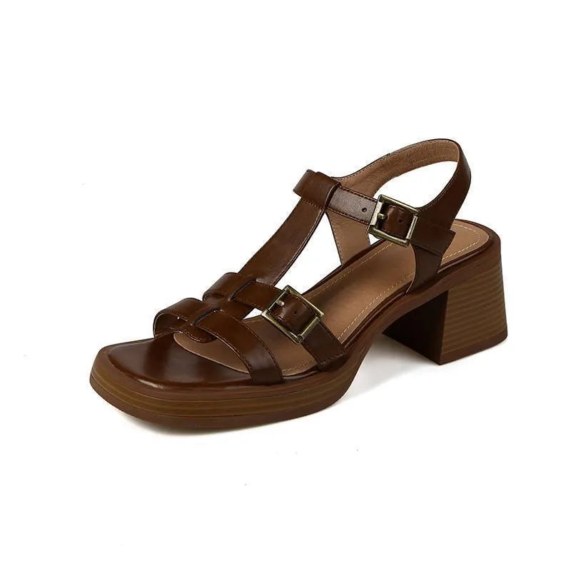 Black retro women's platform sandals with a T-buckle fastening and chunky heel.