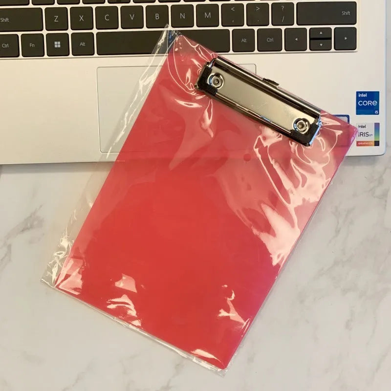 Transparent A4 clipboard with metal clip holding white paper, available in blue, green, red, and white.