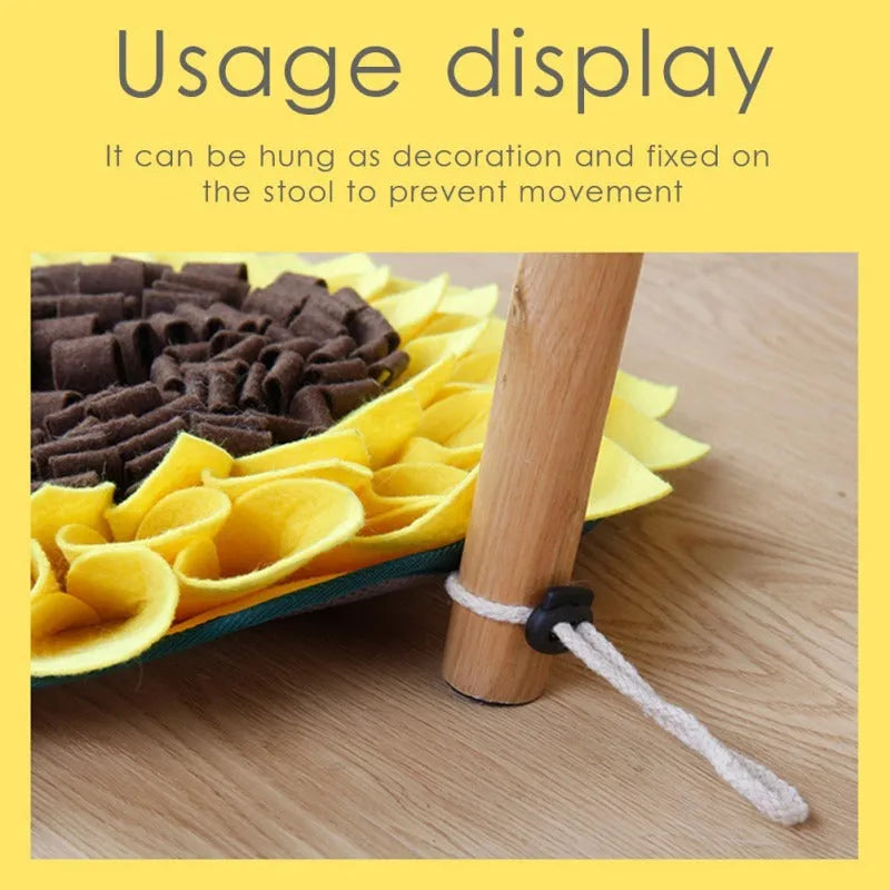 Yellow sunflower-shaped dog snuffle mat with fleece texture and a hanging rope buckle.