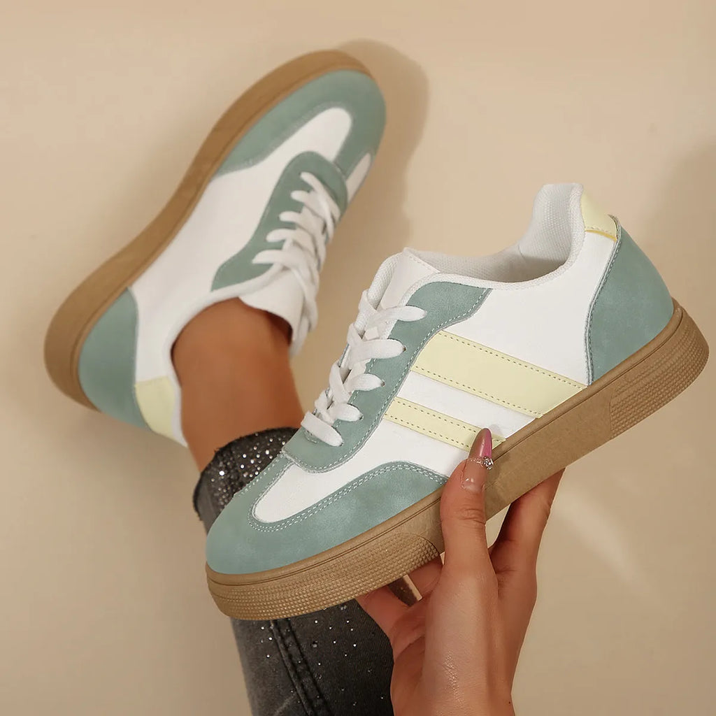 Green women's retro sports low-top shoes with cross straps and round toe on a rubber sole.