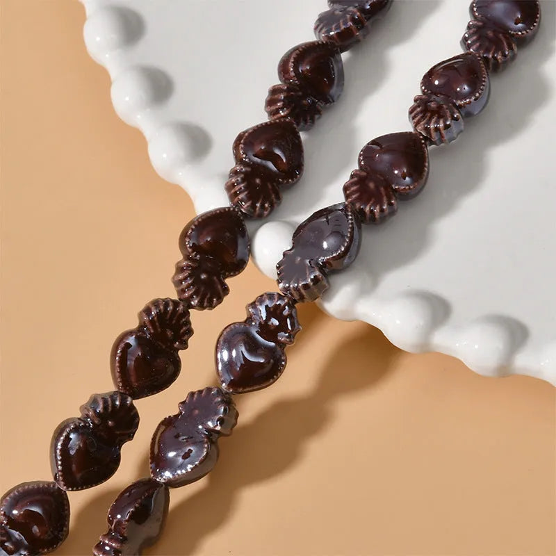 Ceramic heart torch beads in various colours for jewellery making, approximately 10mm by 15mm with straight hole