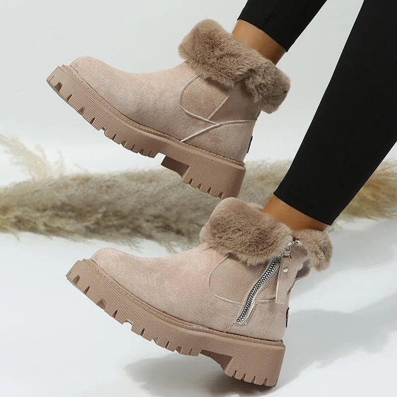 Women's black snow boots with foldable plush tube, suede upper, and rubber sole on winter pavement