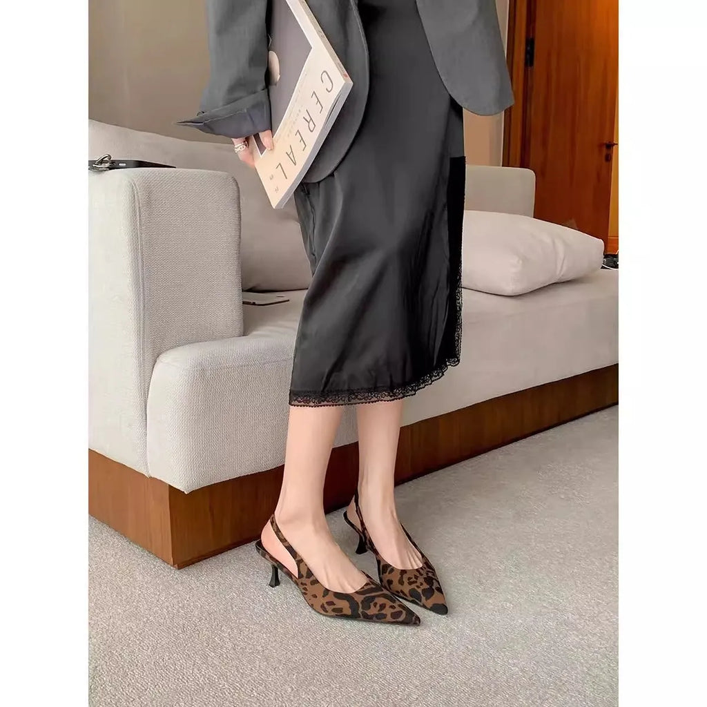Women's pointed toe stiletto high heel pumps in black and nude with microfiber upper