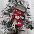 Set of three large 18-inch Christmas stockings with Santa, Snowman, and Reindeer 3D applique designs, hanging on a wooden mantel with festive decorations.