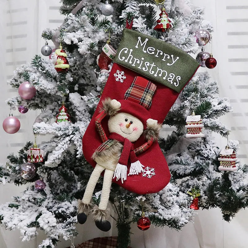 Set of three large 18-inch Christmas stockings with Santa, Snowman, and Reindeer 3D applique designs, hanging on a wooden mantel with festive decorations.