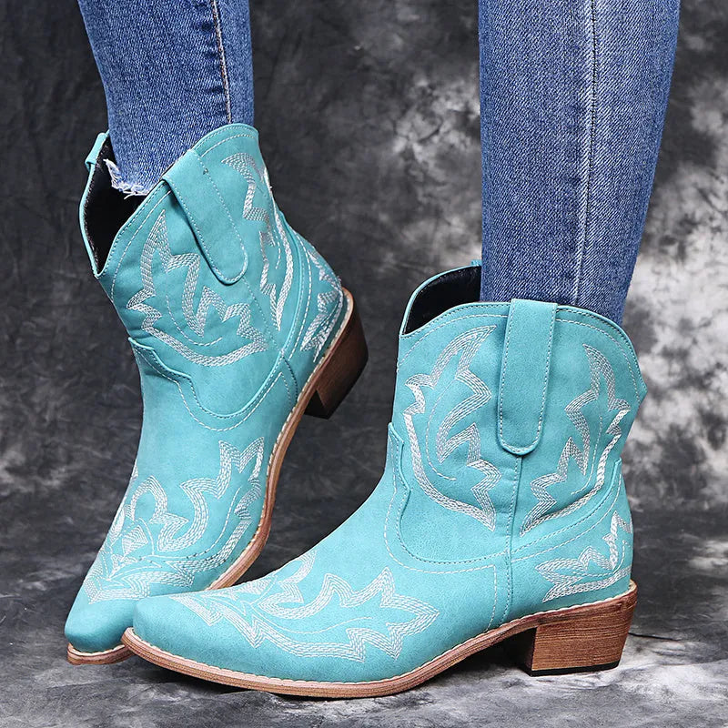 Blue women's cowboy boots with embroidery on the shaft and a low wedge heel.