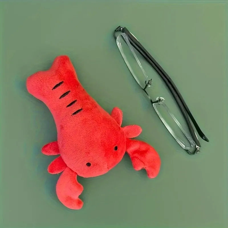 Red plush lobster-shaped squeaky dog toy for small and medium breeds.