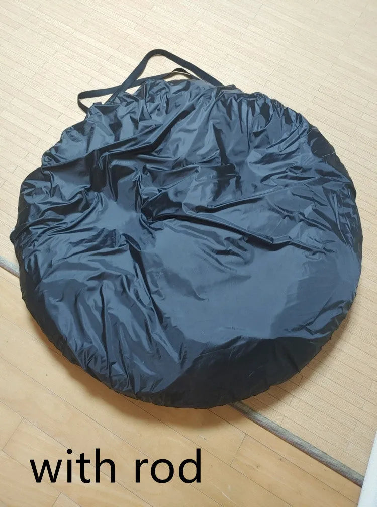 Black pop-up tailgate tent unfolded next to a car, showing its cubic 200cm shape and quick-throw design.