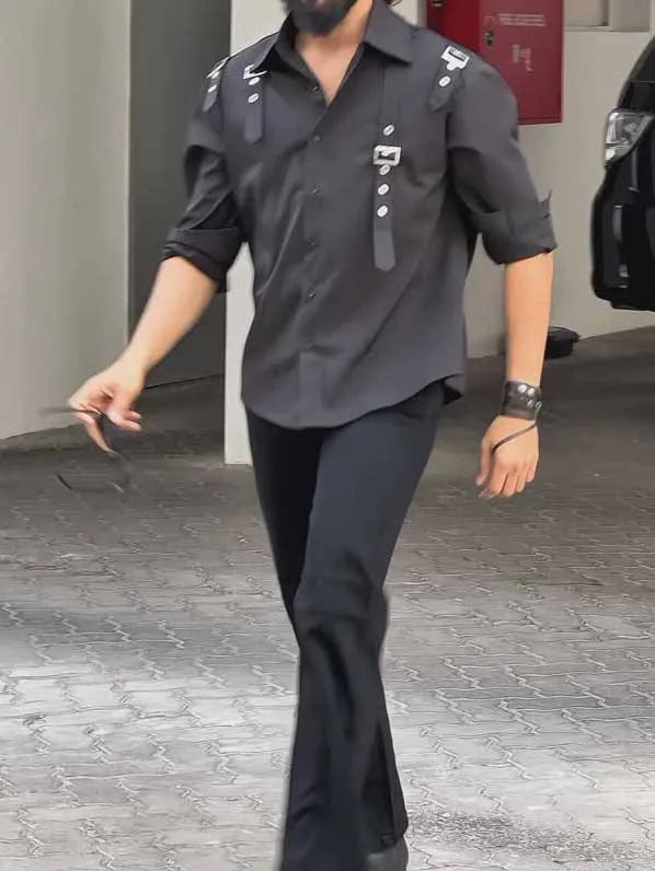 Man wearing a black regular-fit polyester button-up shirt for casual daily wear.