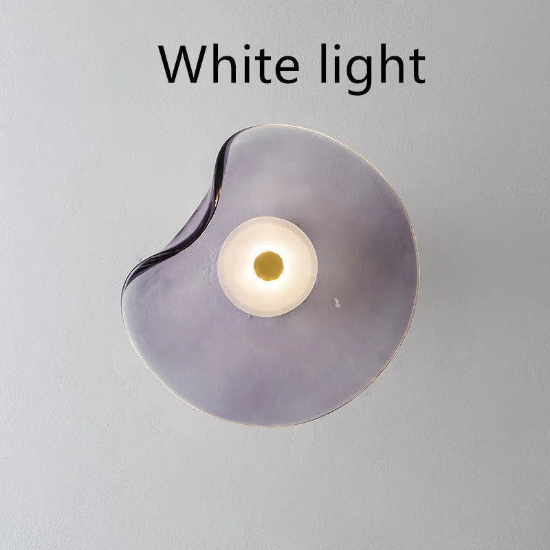 Round glass bedside wall lamp in cognac, light purple, or smoky grey colour.